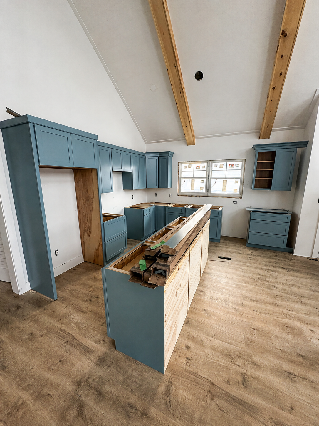 Blue kitchen cabinetry and island during installation